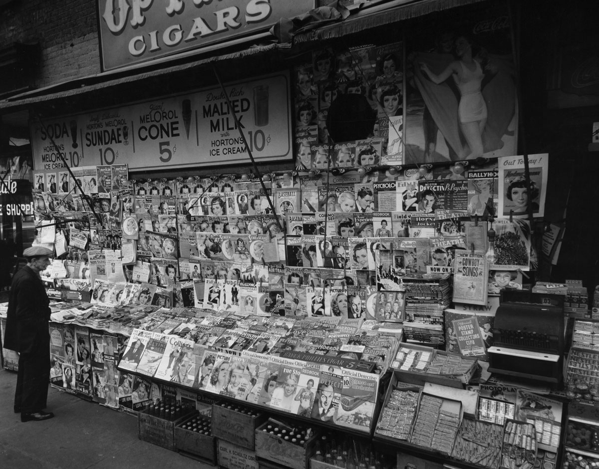 Newsstand, 32nd Street and Third Avenue, New York City (November 19, 1935) by Berenice Abbott.